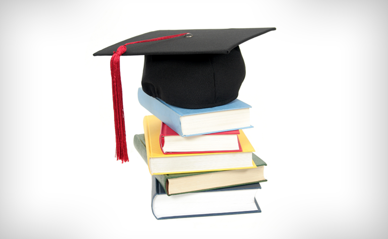 Graduation cap on top of text books