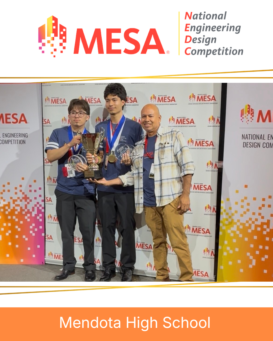 Two students holding a trophy with their teacher next to them